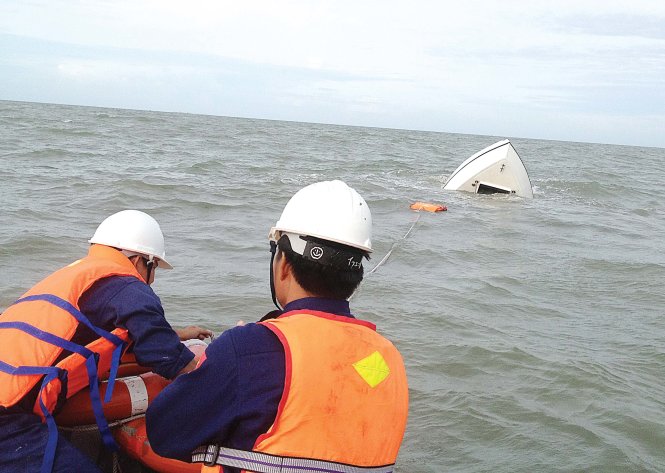 Nhân viên cứu hộ tìm cách kéo tàu BP 12-04-02 vào bờ - Ảnh: VIỆT NAM MRCC