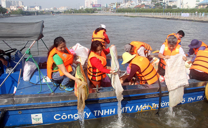 Đoàn thanh niên các đơn vị và người dân cùng tham gia thả cá trên tuyến kênh Tài Hủ - Bến Nghé sáng ngày 24-4 - Ảnh Q.Khải
