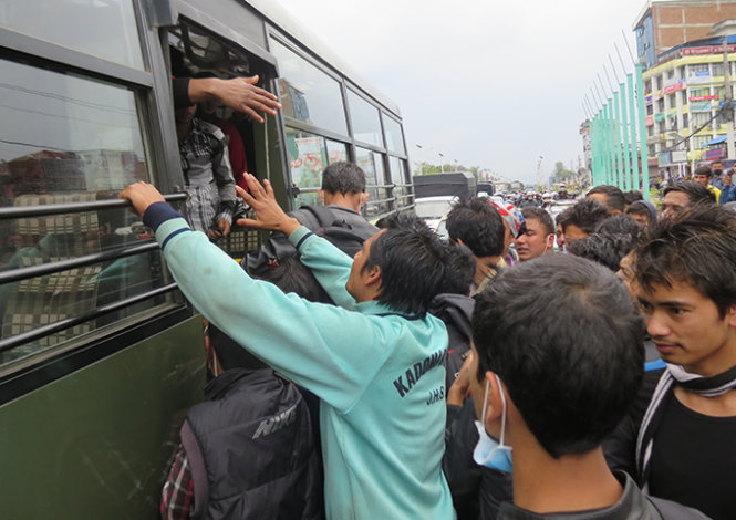 Người dân Nepal chen chúc đòi lên một xe buýt của quân đội để tháo chạy khỏi Kathmandu nhưng bị cảnh sát và quân đội cản lại - Ảnh: Việt Phương 