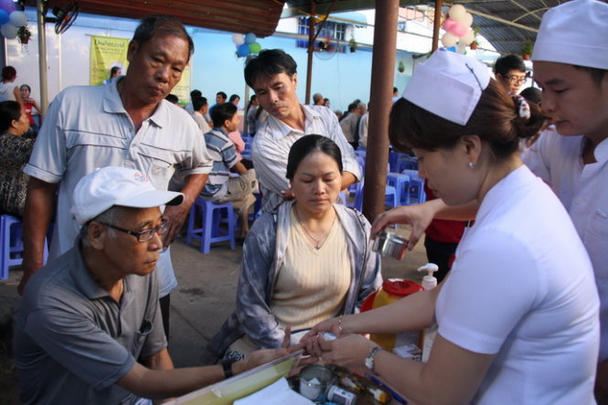 Bác sĩ bệnh viện quận Thủ Đức đo đường huyết miễn phí cho người dân - Ảnh: Hữu Khoa