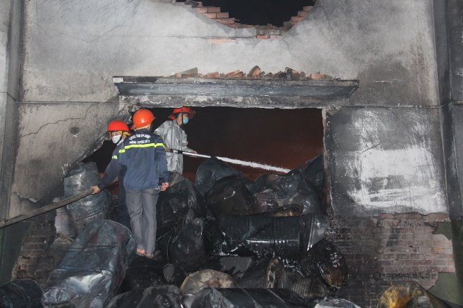 Hàng trăm thùng phuy chứa sơn và hóa chất bị lửa thiêu rụi sau vụ cháy - Ảnh: Đình Trọng