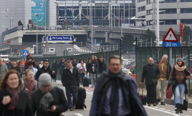Du khách rời sân bay tại Brussels sau khi vụ đánh bom tự sát xảy ra Ảnh: Reuters