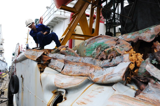 Phần vỏ tàu kiểm ngư 951 bị rách toác sau cú đâm va với tàu Trung Quốc đang được các công nhân, kỹ sư của Sông Thu xử lý gia cố - Ảnh: Đ.Nam