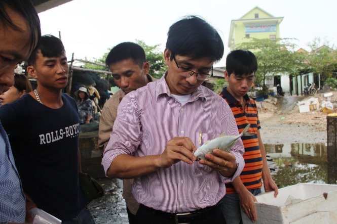 Cán bộ thuộc đoàn công tác kiểm tra, lấy mẫu cá nuôi lòng chết tại khu vực đầm Lập An (thị trấn Lăng Cô, Phú Lộc, Thừa Thiên - Huế) - Ảnh: Nhật Linh