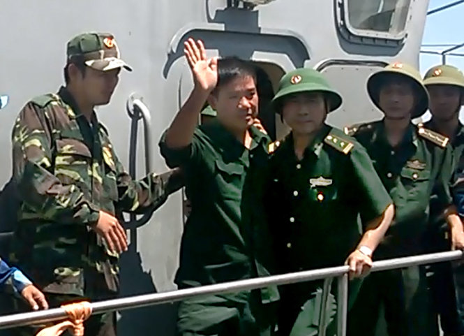 Phi công Nguyễn Hữu Cường vẫy tay chào mọi người tại cầu cảng hải đội 2 Bộ đội biên phòng Nghệ An chiều 15-6 - Ảnh: Doãn Hòa