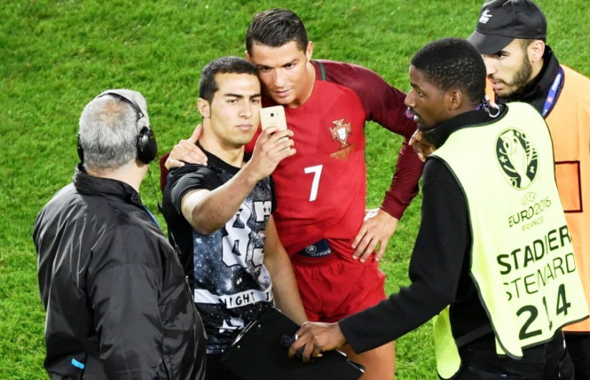 Không ít người bình phẩm chuyện Ronaldo ngăn cản các nhân viên bảo vệ để làm dáng chụp ảnh selfie với người hâm mộ ngay khi kết thúc trận đấu - Ảnh: Reuters