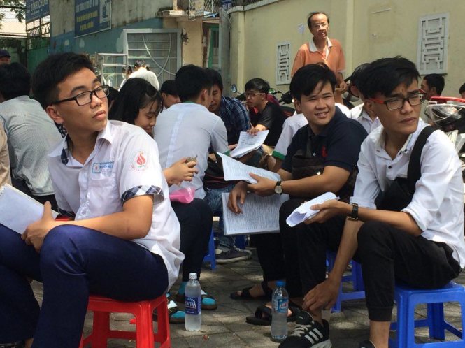 Thí sinh trao đổi bài trước khi vào khu vực thi tại điểm thi Trường THPT Diên Hồng - Ảnh: HẢI QUÂN