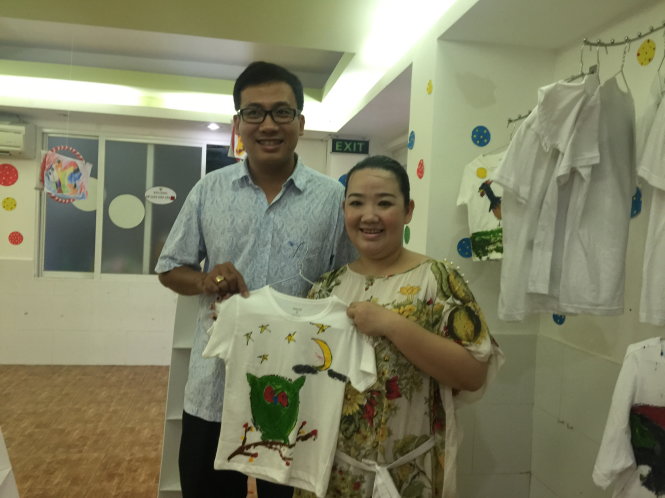 Ba mẹ bé Nguyễn Hoàng Yến (Sơ Ri), học sinh trường SGA vui với sản phẩm của con gái mình - Ảnh: H.T