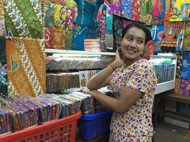 Cô bán vải ở chợ Bogyoke với xấp hình bà Aung San Suu Kyi - Ảnh: NGÔ PHƯƠNG THẢO