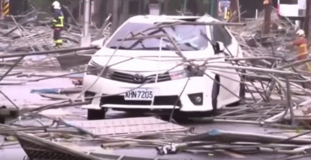 Mảnh vỡ giàn giáo rơi xuống trúng ô tô trong bão - Ảnh chụp từ clip YouTube