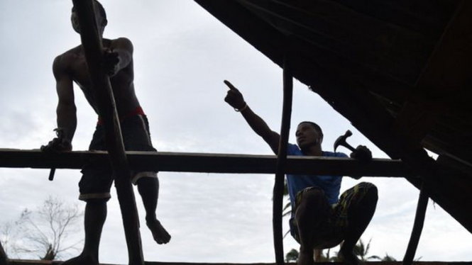 Người dân ở Les Caye sửa nhà sau khi bão qua - Ảnh: AFP