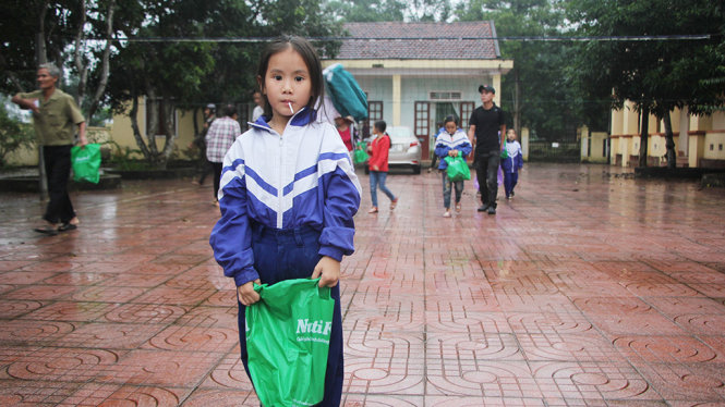Một học sinh huyện Đức Thọ (Hà Tĩnh) vui mừng khi nhận học bổng “Ngăn dòng bỏ học” sau lũ của báo Tuổi Trẻ chiều 31-10 - Ảnh: DOÃN HÒA