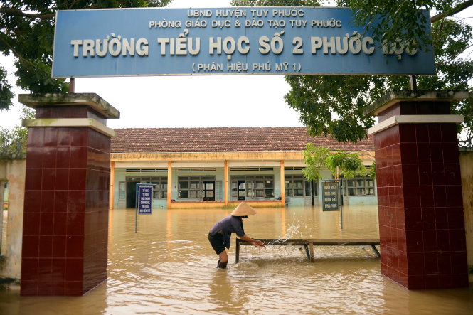 Nước lũ làm cổng Trường Tiểu học số 2 Phước Lộc, (huyện Tuy Phước, tỉnh Bình Định) đổ ngã - Ảnh: Hữu Khoa