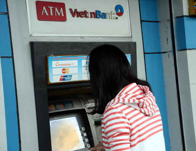 Người dân rút tiền từ thẻ ATM tại Ngân hàng VietinBank trên đường Phan Đình Phùng,  Q.Phú Nhuận, TP.HCM chiều 10-2 - Ảnh: Tự Trung