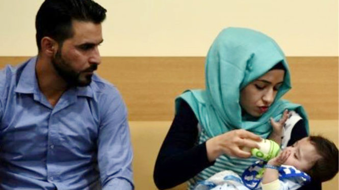 Cha mẹ và bé Karam sau khi đã trải qua phẫu thuật loại bỏ các chi thừa - Ảnh: AFP