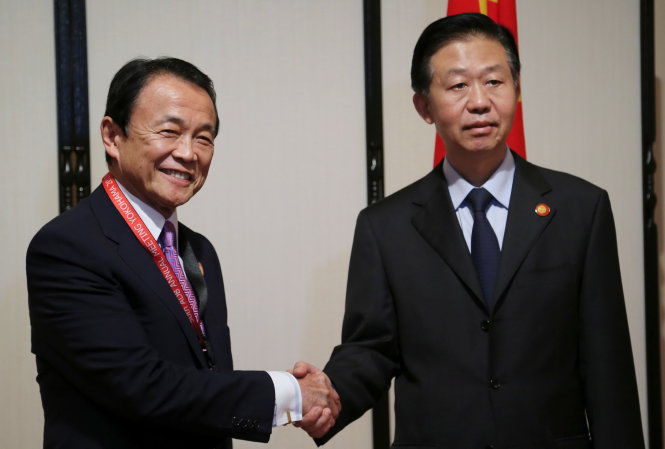 Bộ trưởng Nhật Taro Aso bắt tay với bộ trưởng Tài chính Trung Quốc Tiêu Tiệp tại Yokohama ngày 6-5 - Ảnh: Reuters