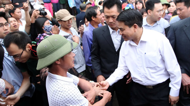 Chủ tịch UBND TP Hà Nội Nguyễn Đức Chung bắt tay với người dân xã Đồng Tâm sau khi buổi đối thoại giữa lãnh đạo TP Hà Nội và người dân địa phương kết thúc - Ảnh: NGUYỄN KHÁNH