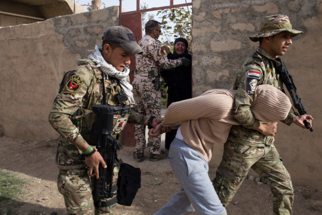 Hình ảnh các binh sĩ Iraq ngược đãi nghi can IS - Ảnh: Ali Arkady