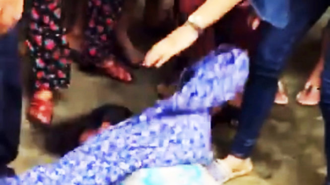 Người phụ nữ bị người dân ở xã Mai Đình vây đánh ngất ra đất - Ảnh cắt từ clip