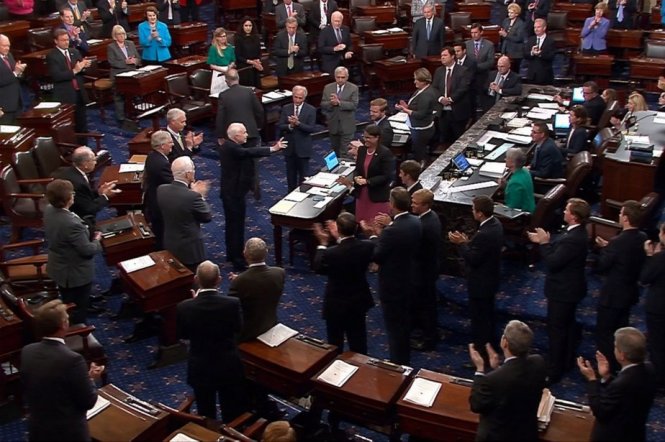 TNS John McCain (giữa) được các TNS trong phòng họp đứng dậy vỗ tay hoan nghênh ông rút thời gian dưỡng bệnh quay về làm việc - Ảnh: REUTERS