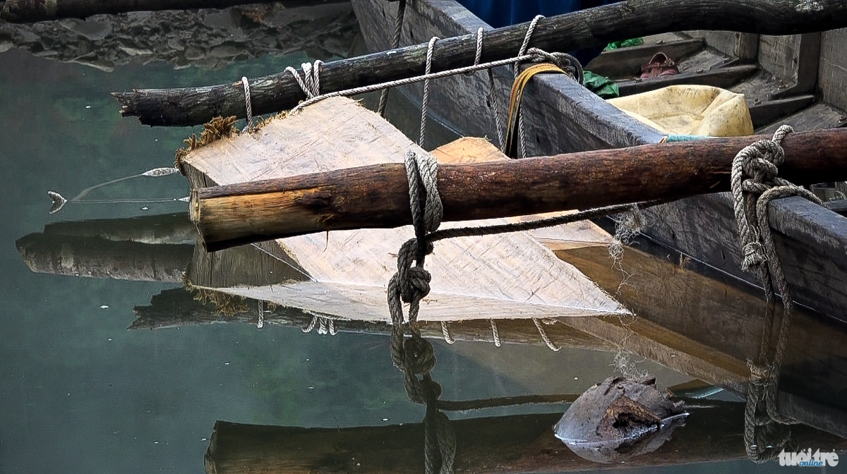 Gỗ lậu được lấy từ lòng hồ, dùng thuyền máy lai dắt gỗ vào bãi tập kết gần bờ