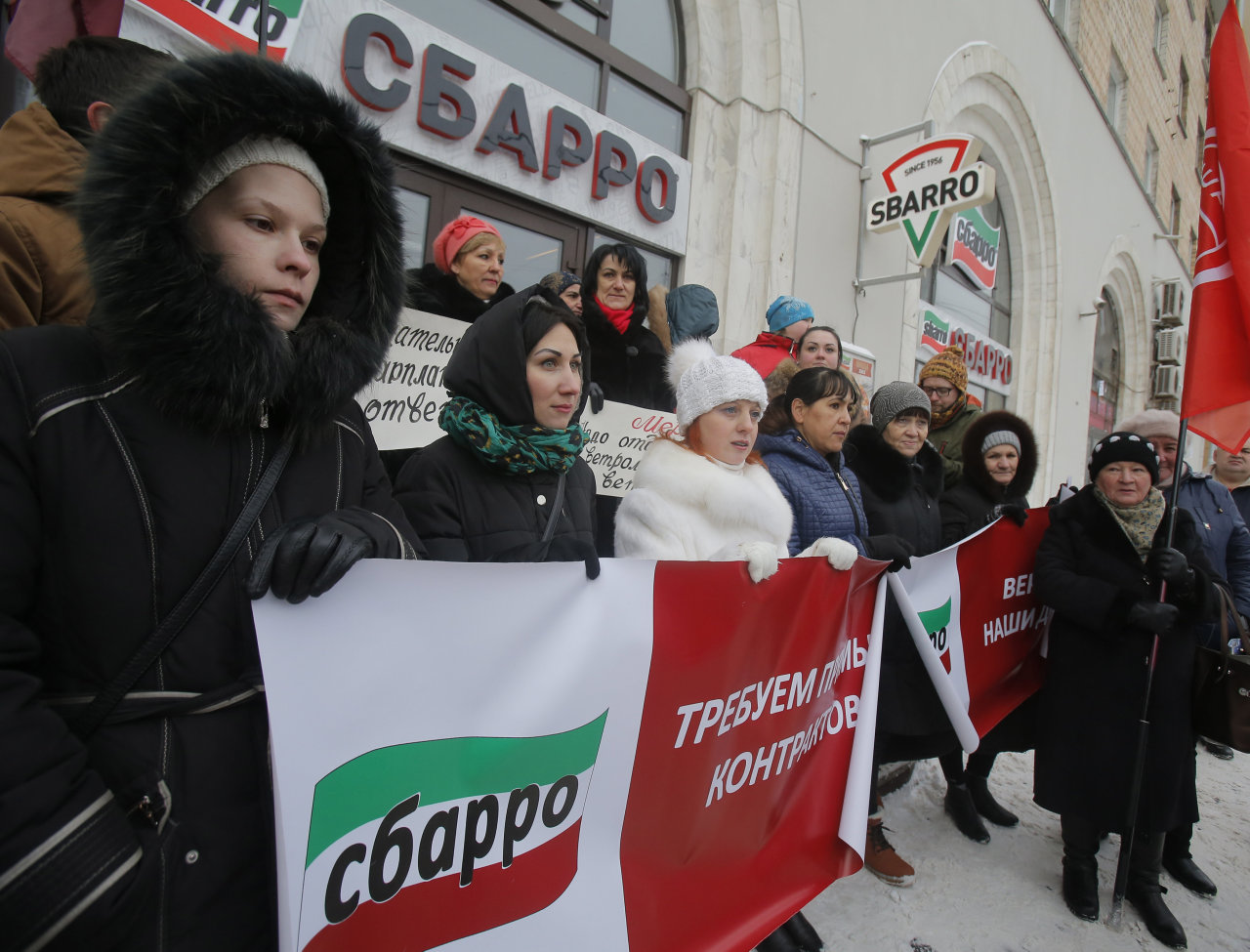 Nhân viên cửa hàng bánh pizza ở Matxcơva đứng trước cửa hàng đòi được trả lương ngày 20-1 - Ảnh: Reuters