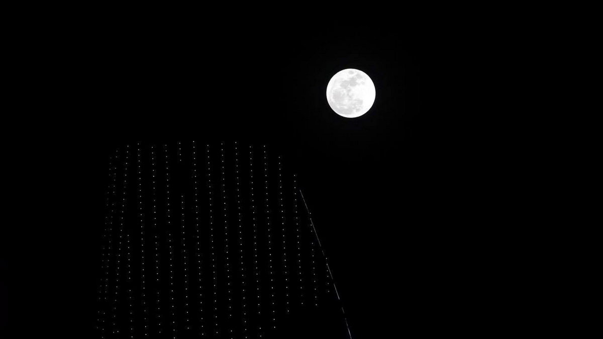 Hình ảnh siêu trăng lúc 19g40 trên nóc tòa nhà Bitexco TP.HCM - Ảnh: Thuận Thắng