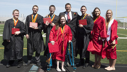 7 anh em nhà McCaughey chụp hình cùng hiệu trưởng (giữa) trong lễ tốt nghiệp trung học - Ảnh: Daily Mail