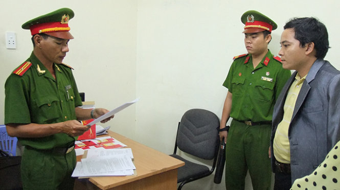 Công an đọc lệnh bắt khẩn cấp Phan Văn Hoàn và lệnh khám xét tại trụ sở công ty Tây Thanh - Ảnh: Như Huệ