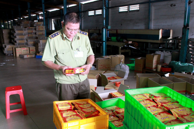 Quản lý thị trường TP.HCM niêm phong tạm giữ hàng hộp bánh quy nghi giả mạo của Công ty Hoàng GIa Phát - Ảnh: Lê Sơn