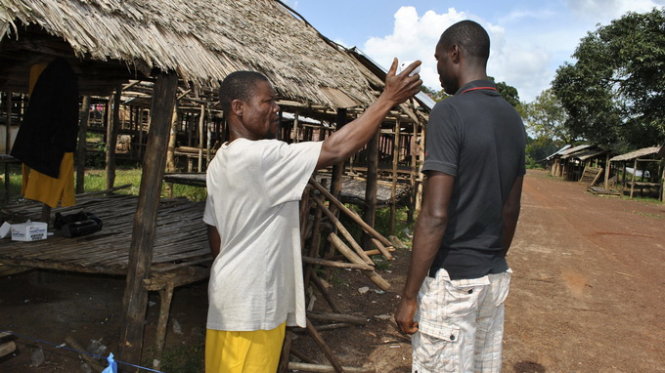 Một tình nguyện viên ở huyện Grand Cape Mount ở Liberia kiểm tra thân nhiệt của người dân địa phương - Ảnh:Reuters