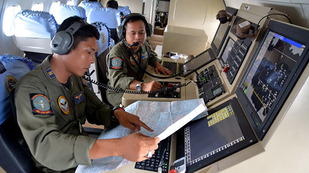 Các phi công của không quân Indonesia trên máy bay CN235 đi tìm máy bay AirAsia mất tích - Ảnh: Reuters