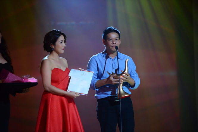 Nhạc sĩ Võ Thiện Thanh (phải) thay mặt ca sĩ Mỹ Tâm đoạt giải Ca sĩ của năm trong lễ trao giải Cống hiến 2015 tại Nhà hát Thành phố, Q.1, TP.HCM tối 6-4 - Ảnh: Quang Định