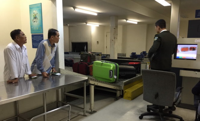 Hành khách đi nước ngoài chờ kiểm tra hành lý ký gửi tại phòng soi của hải quan sân bay quốc tế Tân Sơn Nhất chiều 7-4 - Ảnh: T.Thắng