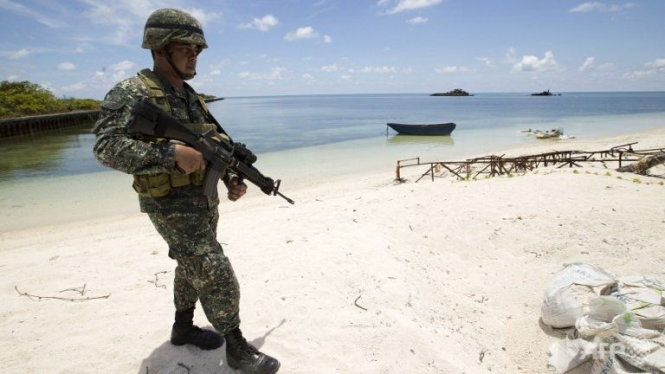 Quân đội Philippines tuần tra trên bãi biển tại một hòn đảo ngày 11-5 - Ảnh: AFP