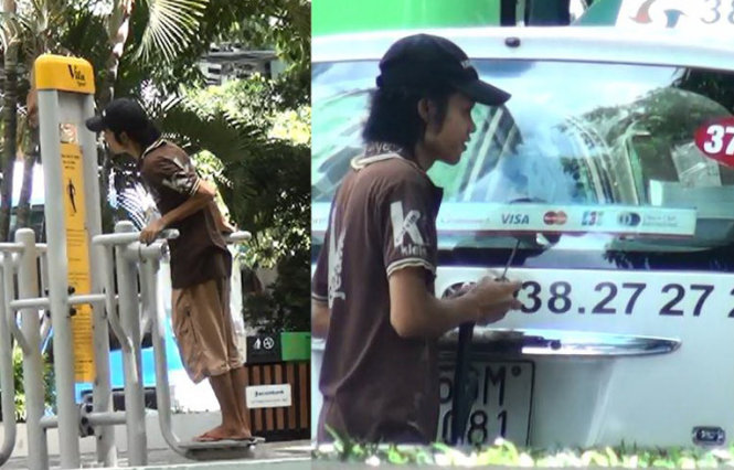 Cường - chuyên trộm phụ tùng - gỡ cần gạt nước một taxi đậu trên đường Lê Lai, Q.1, TP.HCM - Ảnh: Đức Phú