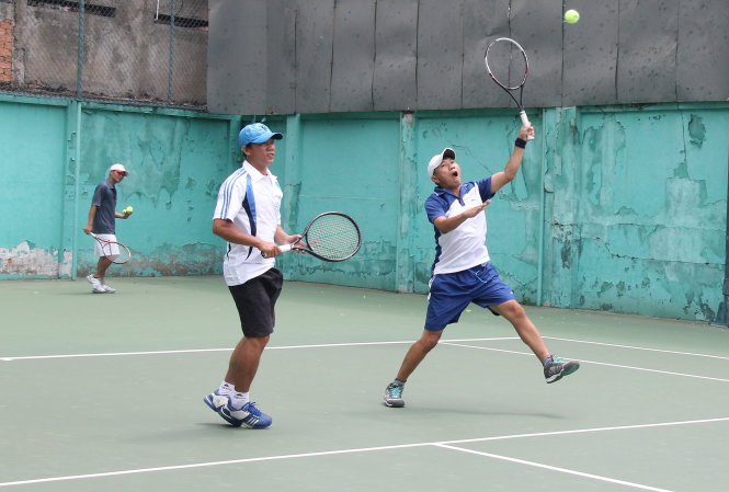 Ông Phan Tôn Ngọc Văn (trái) chơi tennis sau giờ làm việc - Ảnh: Duyên Phan