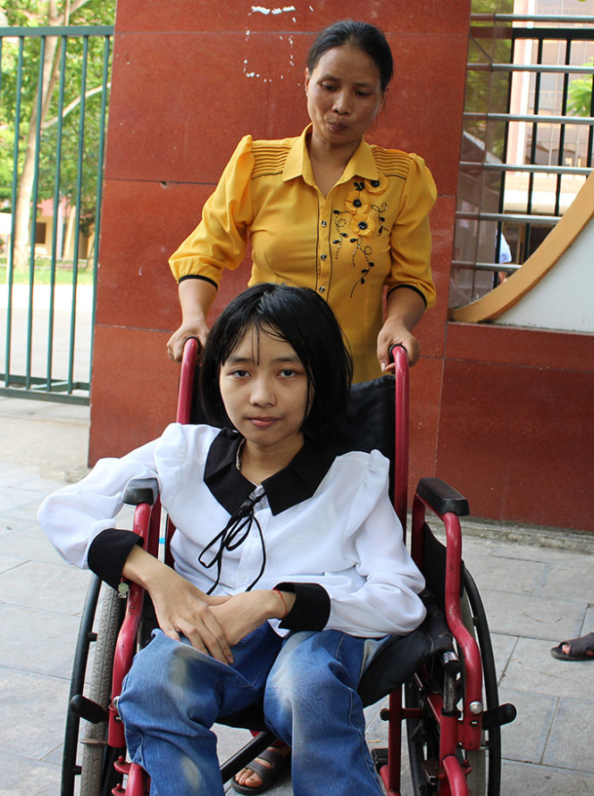Bạn Lê Thị Liên được mẹ đẩy xe lăn đưa đến điểm thi tại Trường THPT chuyên Lam Sơn (Thanh Hóa)- Ảnh: Hà Đồng