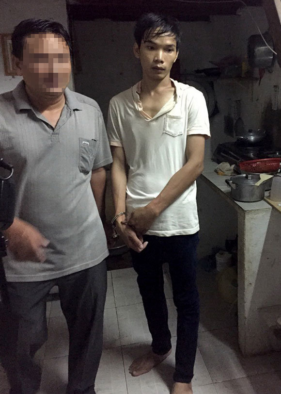 Vũ Văn Tiến (phải), một trong hai nghi phạm gây ra vụ thảm sát, bị đưa về nơi ở để khám xét - Ảnh: Nguồn tin