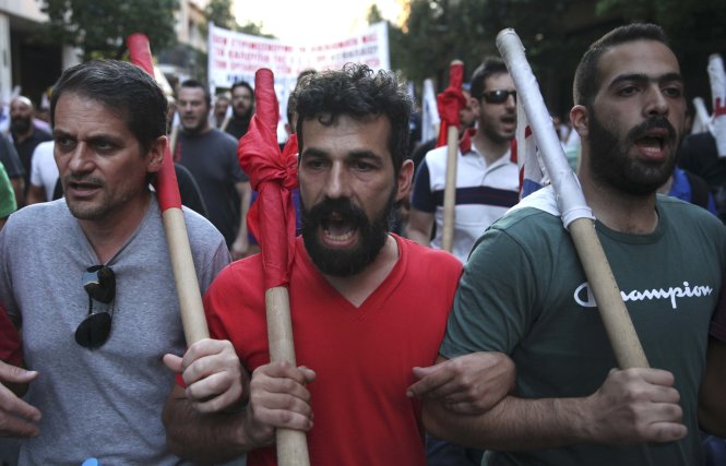 Người Hi Lạp biểu tình chống thắt lưng buộc bụng ở Athens ngày 15-7 khi quốc hội đang bỏ phiếu. Khoảng 50 người bị bắt giữ do có hành động bạo lực chống cảnh sát - Ảnh: Reuters