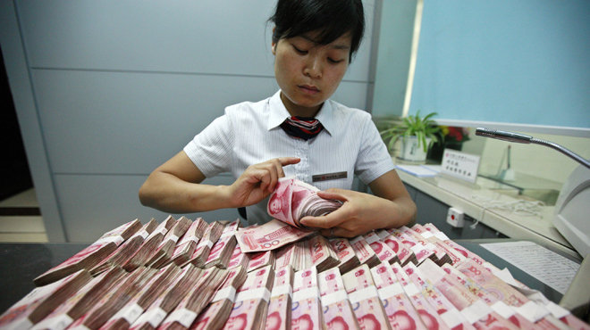Đồng NDT bị phá giá khiến thị trường tài chính toàn cầu đảo lộn - Ảnh: Reuters