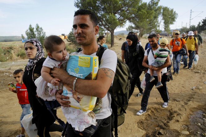 Người nhập cư Syria vượt qua biên giới Hi Lạp ngày 8-9 - Ảnh: Reuters