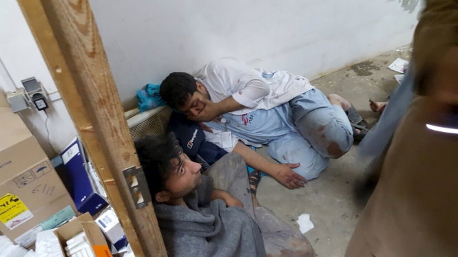 Các nhân viên y tế MSF bàng hoàng sau vụ không kích bệnh viện - Ảnh: Reuters
