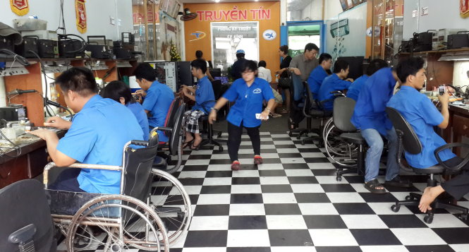 Người khuyết tật làm việc tại cửa hàng sửa chữa điện thoại Truyền Tín (118 Ba Cu, TP Vũng Tàu) - Ảnh: Đ.Hà