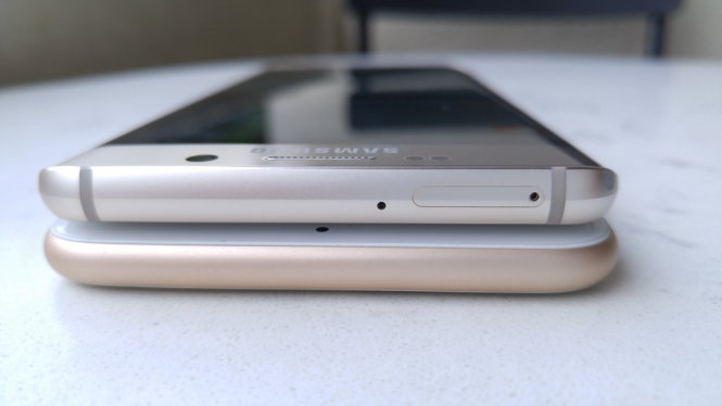 Khe SIM của Galaxy S6 Edge+ nằm ở cạnh trên thân máy, so với cạnh bên của khe SIM iPhone 6S Plus - Ảnh: Thanh Trực