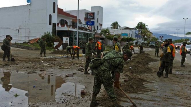 Binh sĩ Mexico dọn dẹp đất cát trên đường phố tại Manzanilli, bang Colima Ảnh: AFP