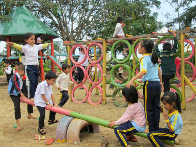 Các em học sinh Trường tiểu học Lê Văn Tám chơi đùa thỏa thích trong khu vui chơi được làm từ đồ tái chế - Ảnh: Khắc Thịnh