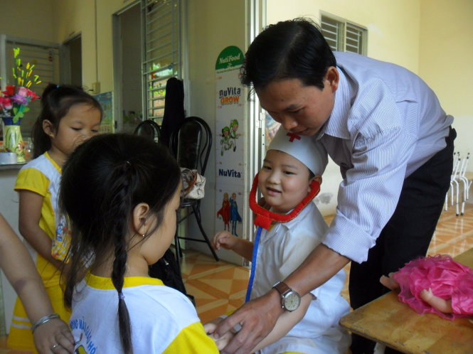 Thầy Trần Văn Cần vui chơi cùng trẻ tại Trường mầm non Hòa An - Ảnh: Hoàng Oanh