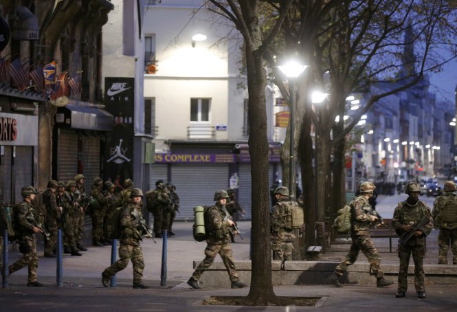 Các quân nhân Pháp lập vành đai bảo vệ khu vực đang diễn ra cuộc bố ráp những nghi can - Ảnh: Reuters