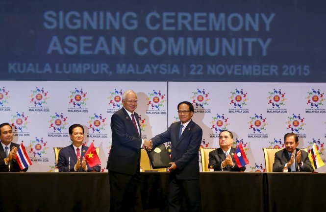 Tổng thư ký ASEAN Lê Lương Minh (phải) và Thủ tướng Malaysia Najib Razak bắt tay xác nhận trong buổi lễ ký kết thành lập Cộng đồng ASEAN ngày 22-11 tại Kuala Lumpur - Ảnh: Reuters
